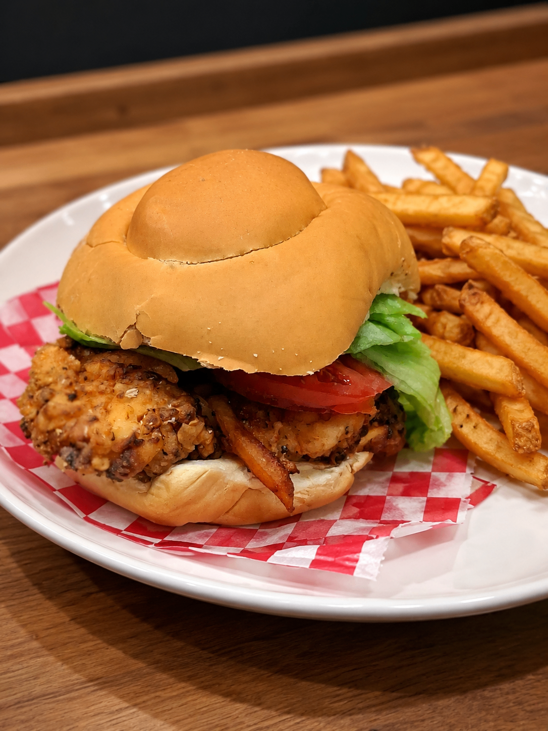 Chicken sandwich and fries on a restaurant table
